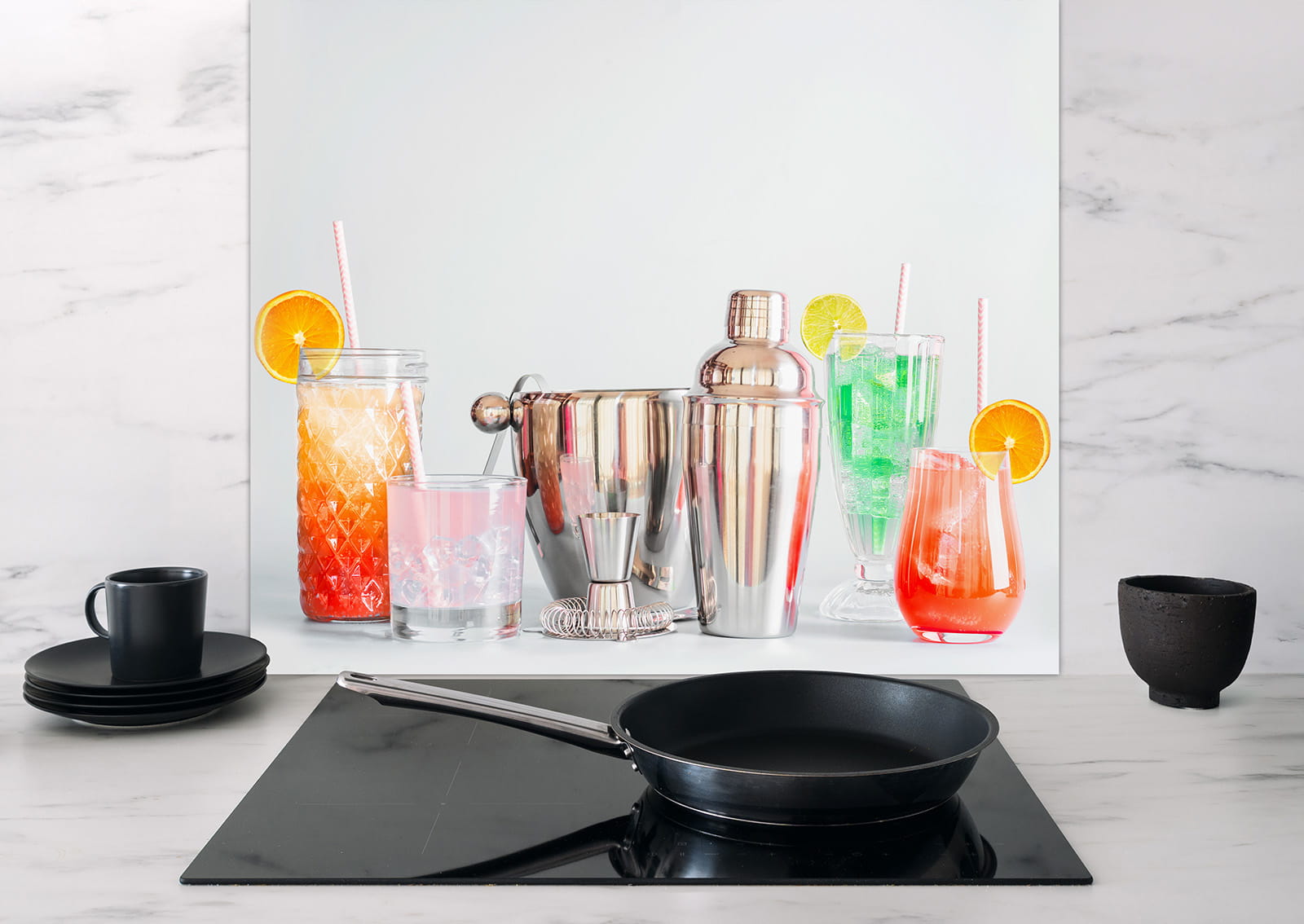 Spritzschutz mit Cocktails und Shaker, zeigt verschiedene Getränke in Gläsern und einen Cocktailshaker auf einer Küchenoberfläche.