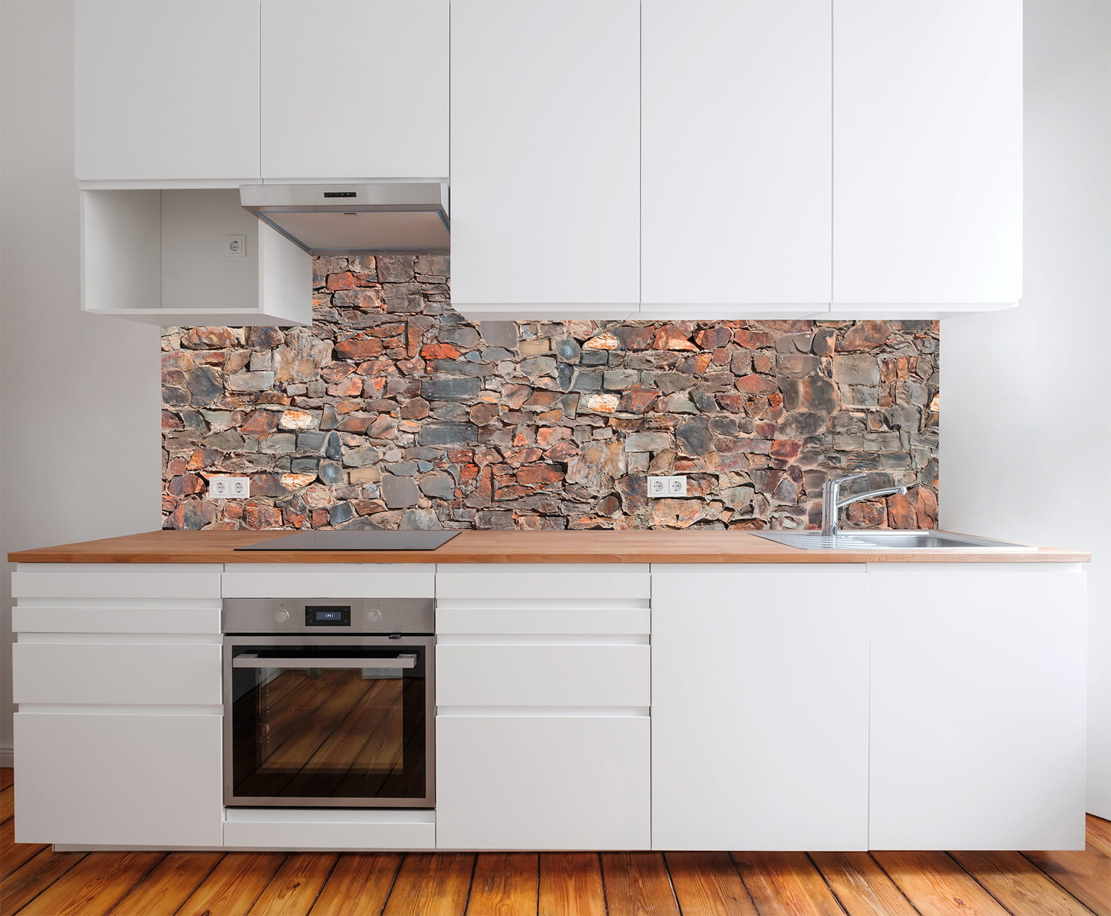 Moderne Küche mit weißem Möbel und Holzarbeitsplatte, im Hintergrund eine Steinmauer als Wandverkleidung.