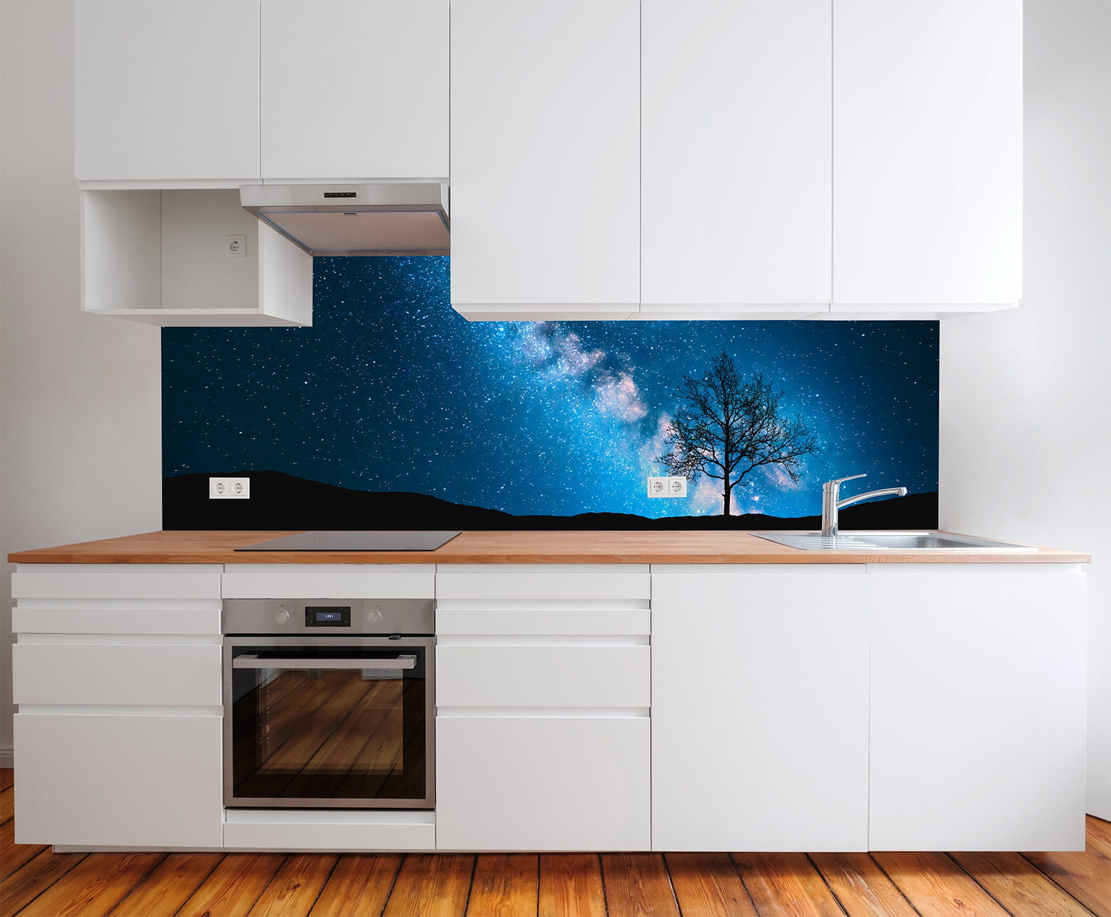 Küchenrückwand mit Motiv der Milchstraße, Baum und Sternenhimmel, moderne weiße Küchenschränke und Holzarbeitsplatte.